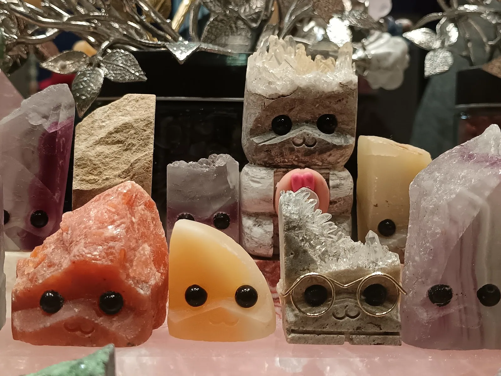 A shelf full of pet rocks, each one different