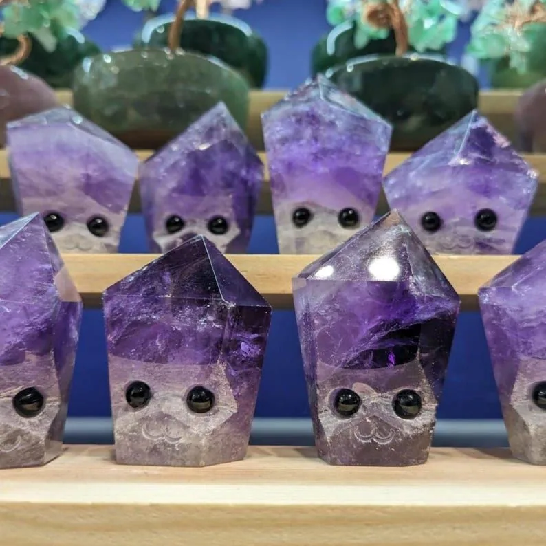 An amethyst crystal buddy with a little face