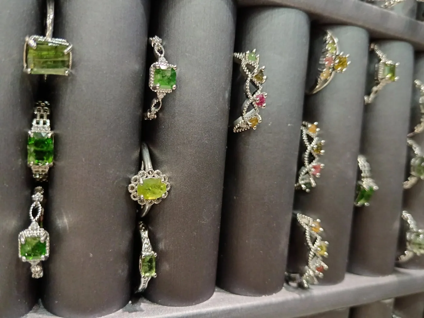 Peridot rings on a display tray