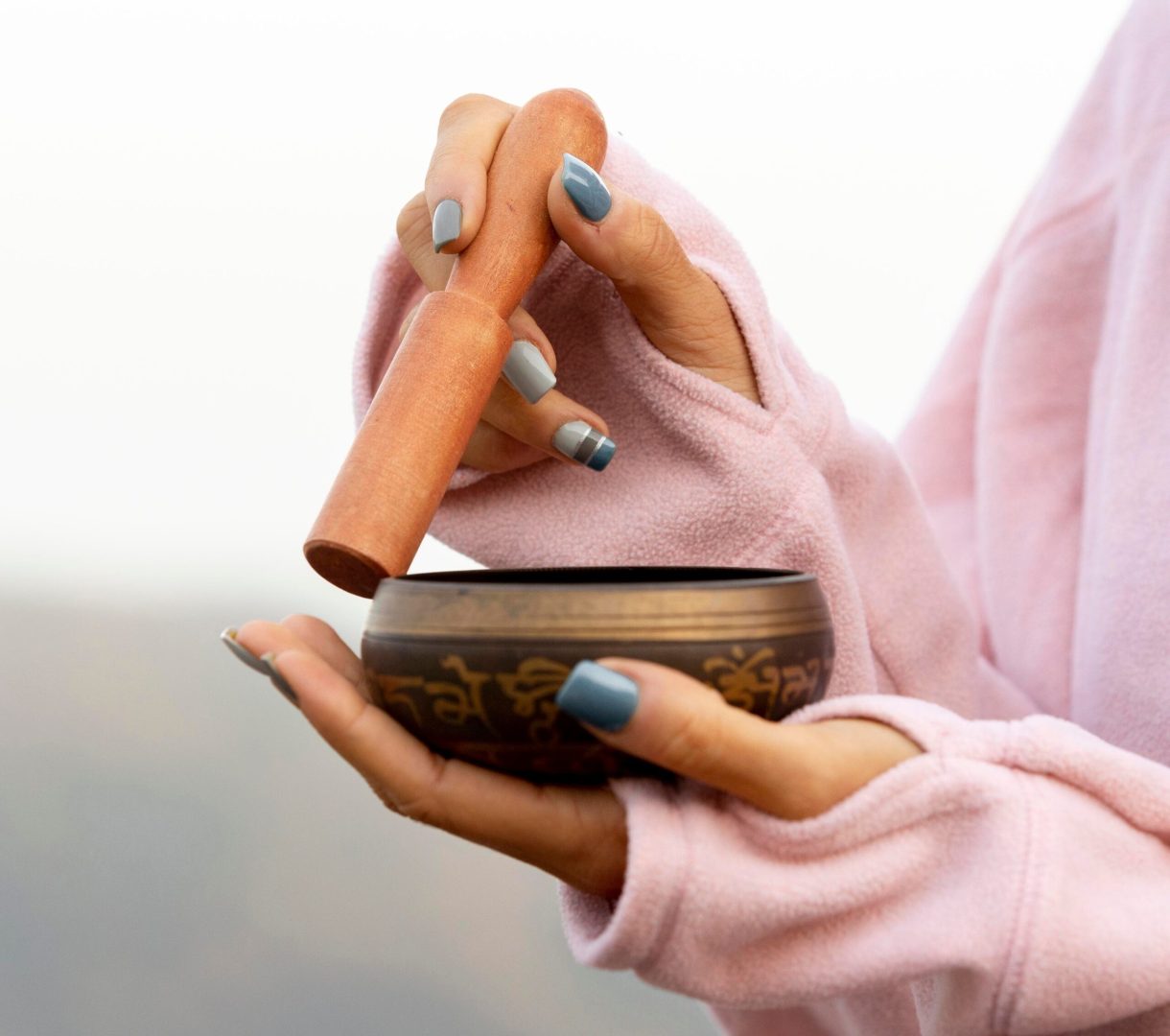 side-view-woman-outdoors-holding-singing-bowl (1)